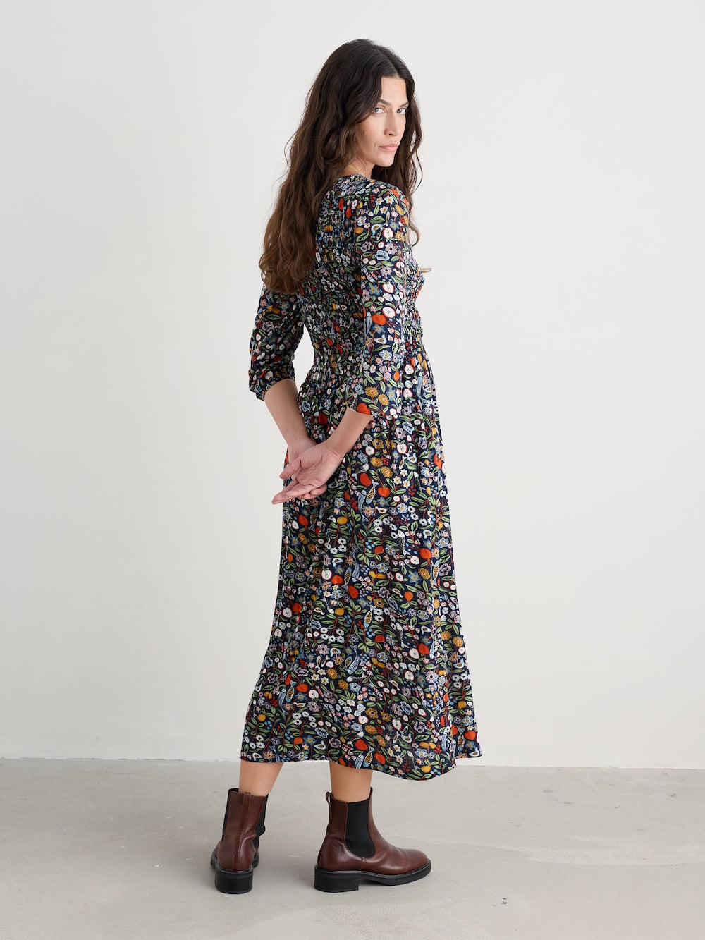 Woman wearing a floral dress with a plain background