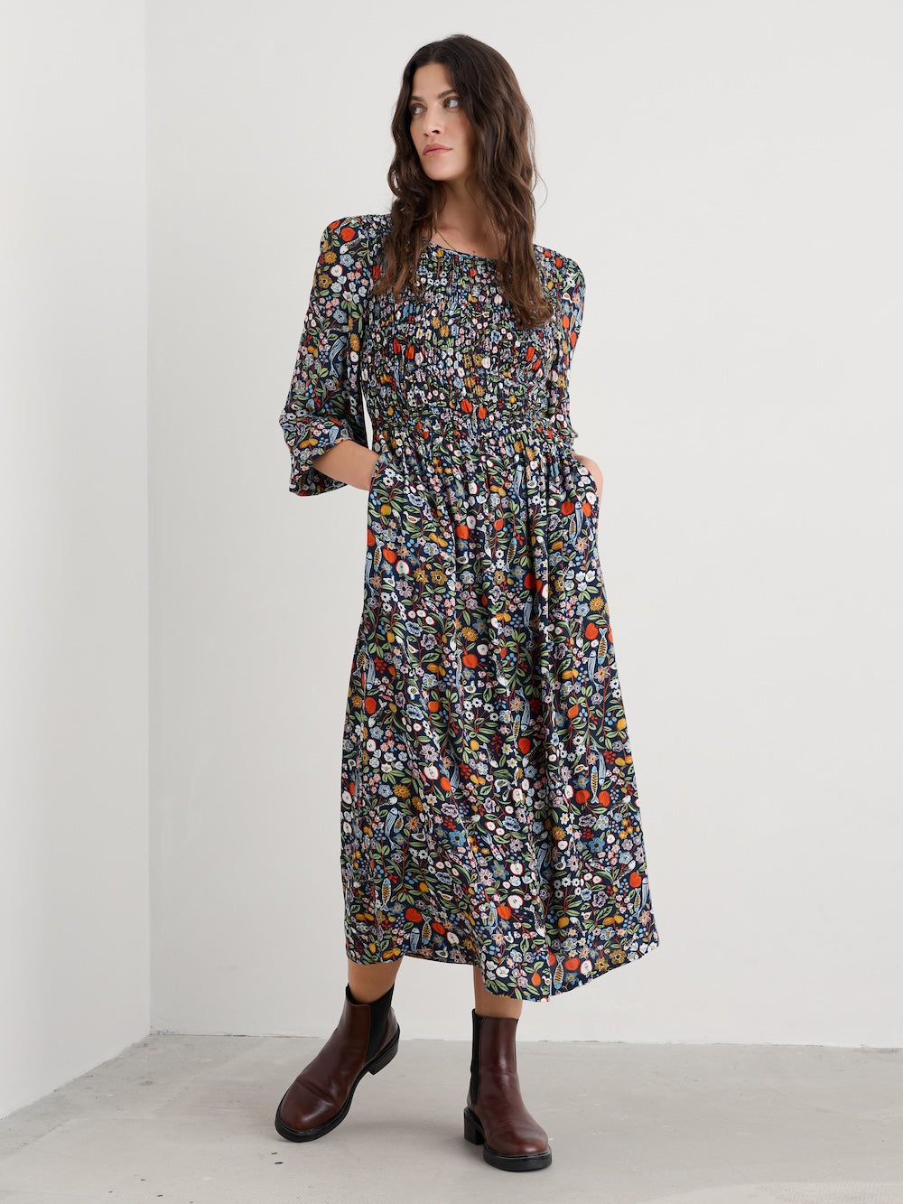 Woman wearing a floral dress with a plain background