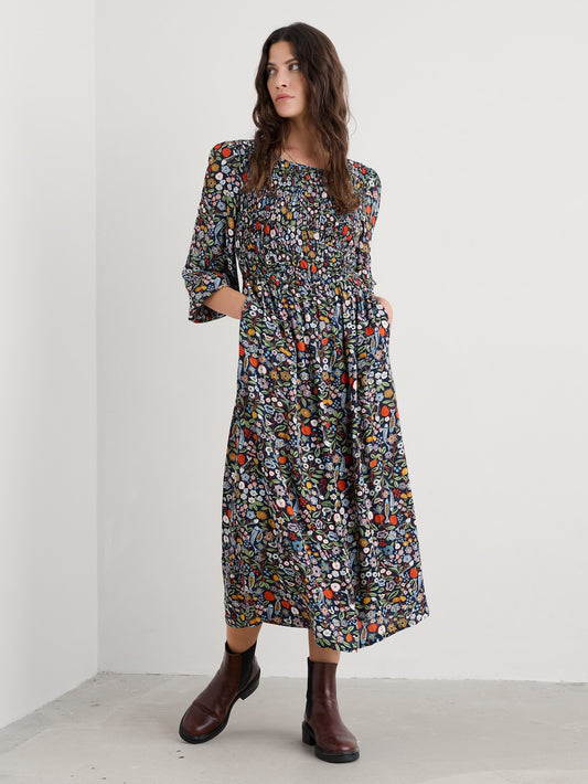 Woman wearing a floral dress with a plain background