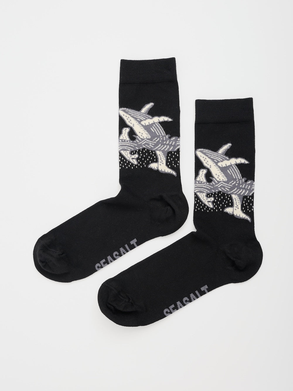 Black socks with whale design on a white background