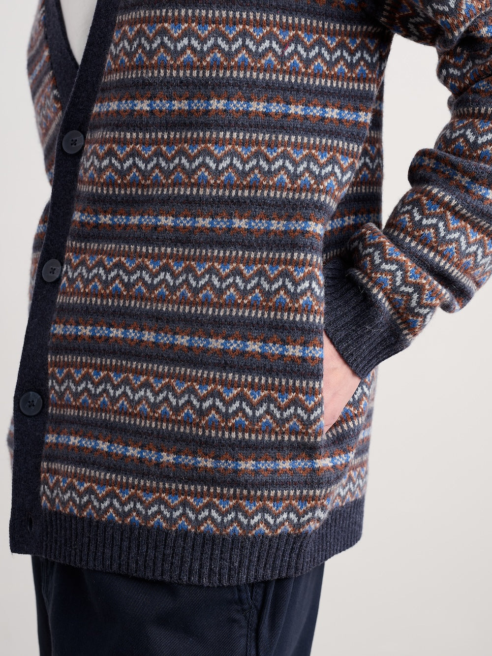 Patterned cardigan with a focus on the fabric design against a neutral background