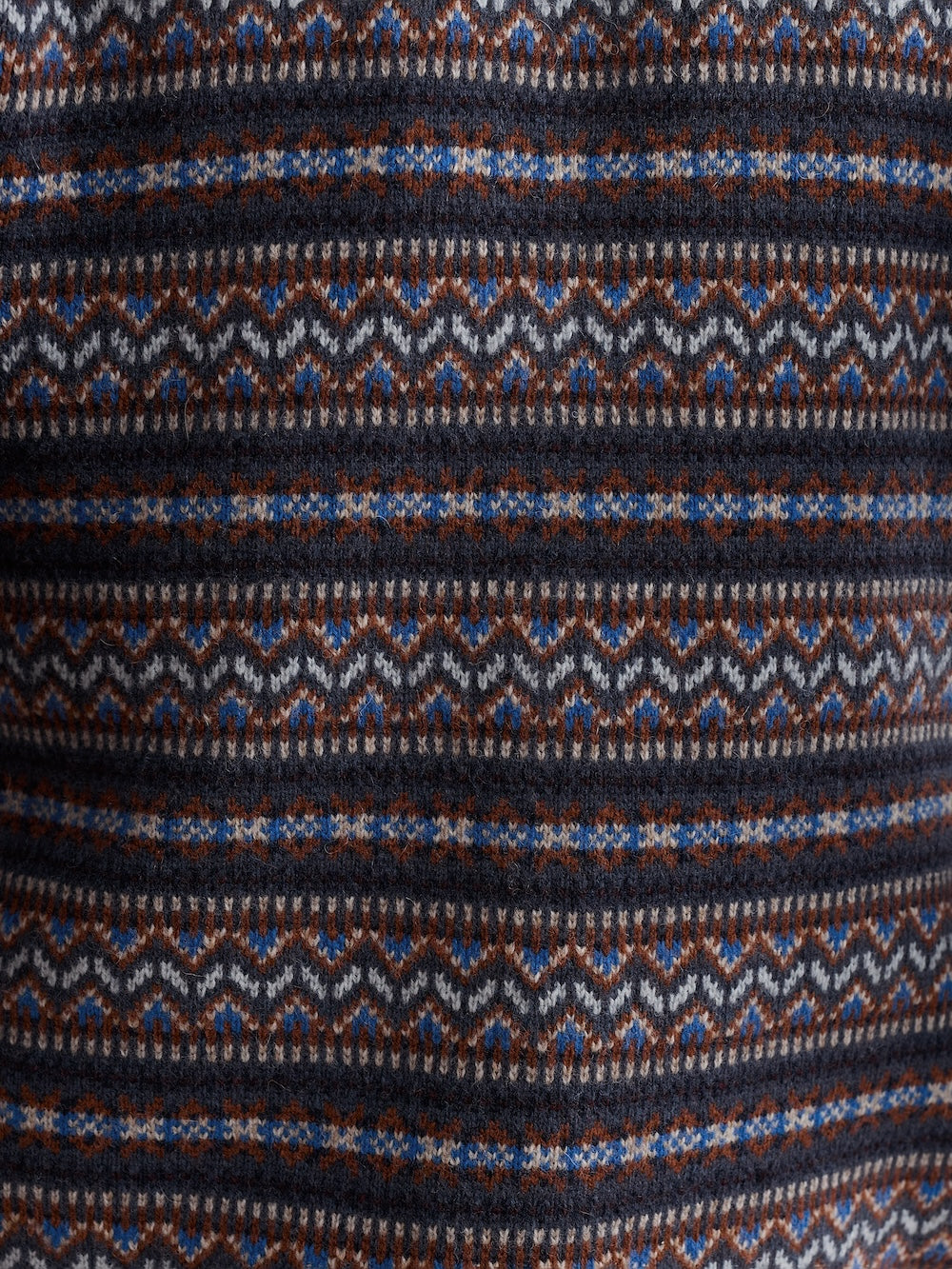 Close-up of a patterned fabric with blue, brown, and white colors.