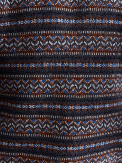 Close-up of a patterned fabric with blue, brown, and white colors.
