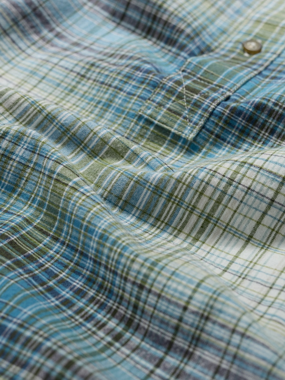 Close-up of a plaid fabric with blue and green colors