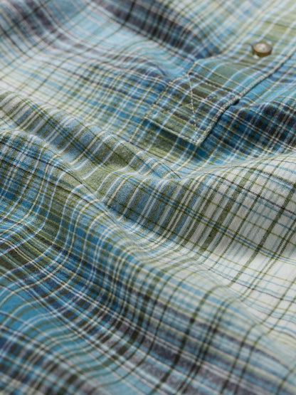 Close-up of a plaid fabric with blue and green colors
