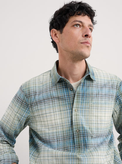 Man wearing a plaid shirt against a plain background