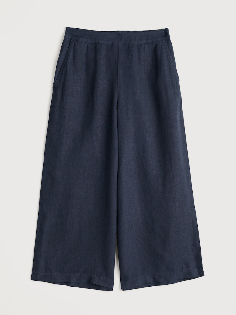 Navy blue wide-leg pants on a light gray background