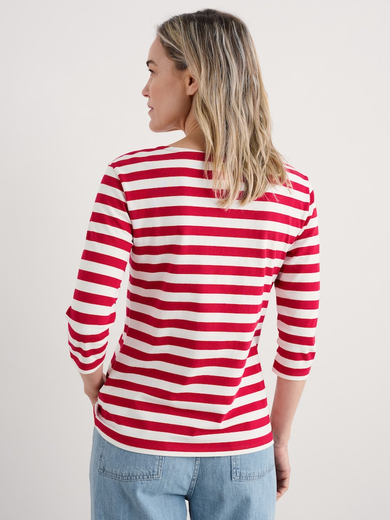 Woman wearing a red and white striped shirt on a plain background