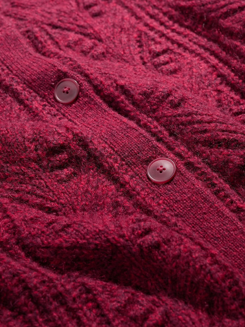 Close-up of a red knitted cardigan with buttons