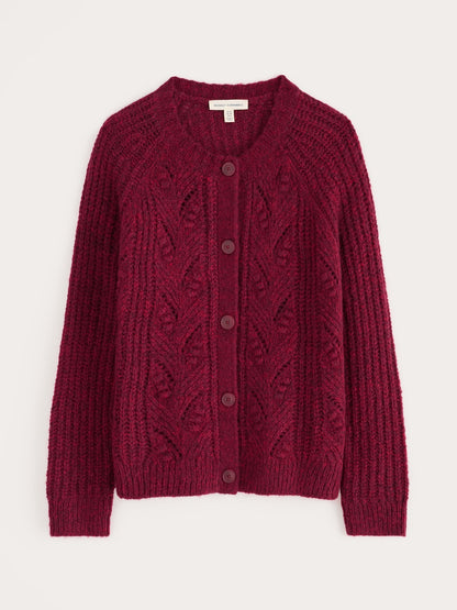 Red knitted cardigan with cable pattern on a white background