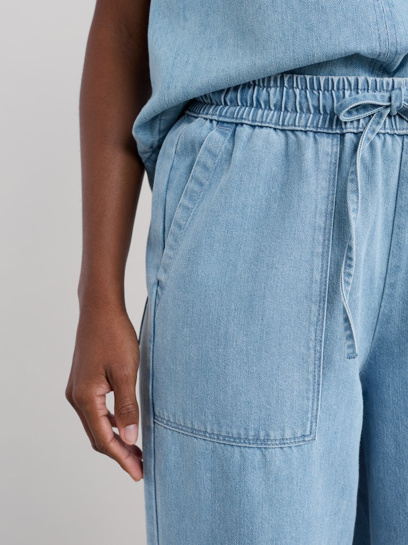 Light blue denim pants with a plain background