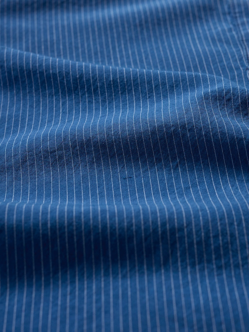 Close-up of blue fabric with white pinstripes