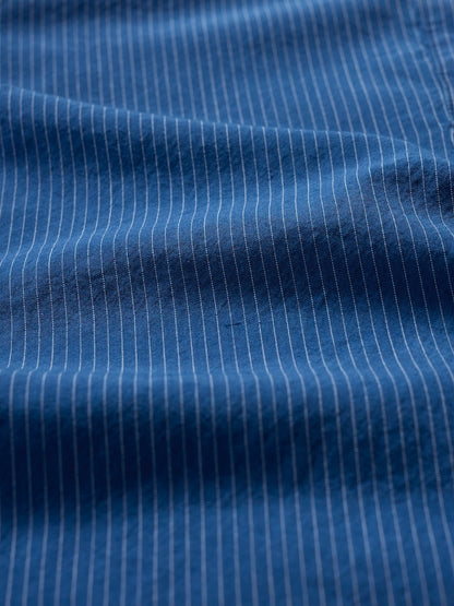 Close-up of blue fabric with white pinstripes