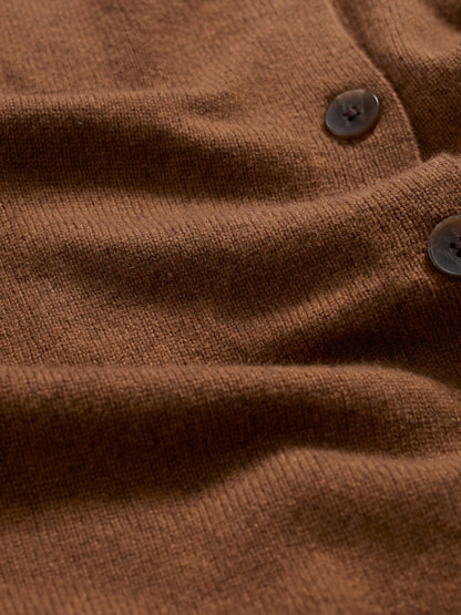 Close-up of a brown textured fabric with buttons