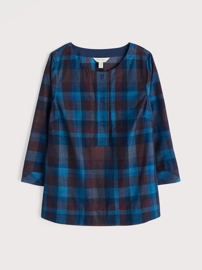 Blue and red plaid shirt on a light gray background