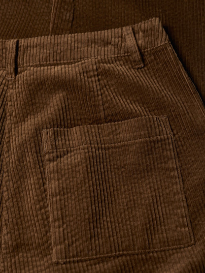 Close-up of brown corduroy pants with a pocket