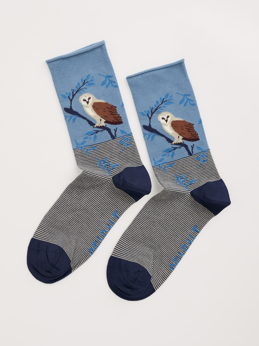 Pair of socks with owl design on a light gray background