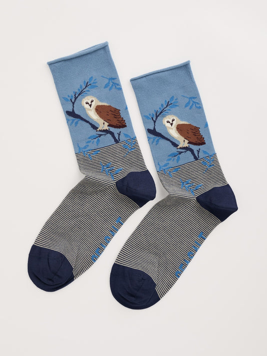 Pair of socks with owl design on a light gray background