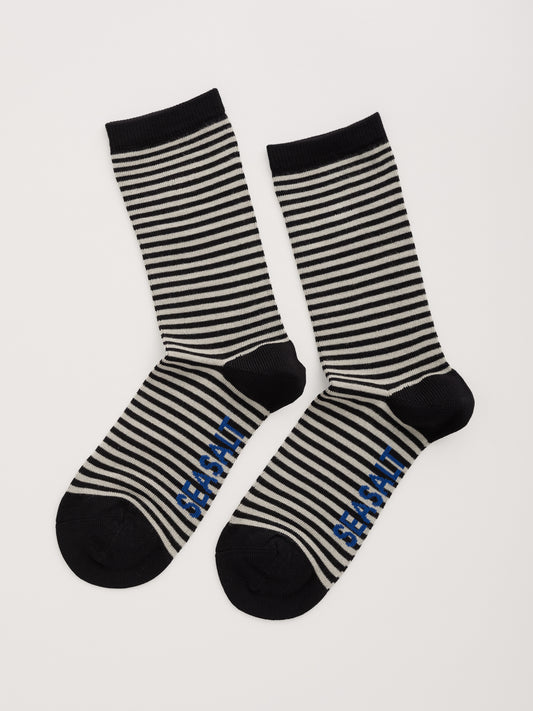 Black and white striped socks with 'Seasalt' branding on a light gray background