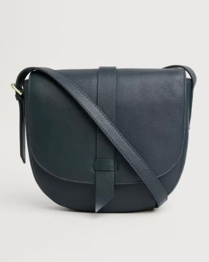 Navy leather crossbody bag on a light gray background