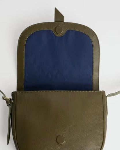 Green leather bag with blue interior on a white background