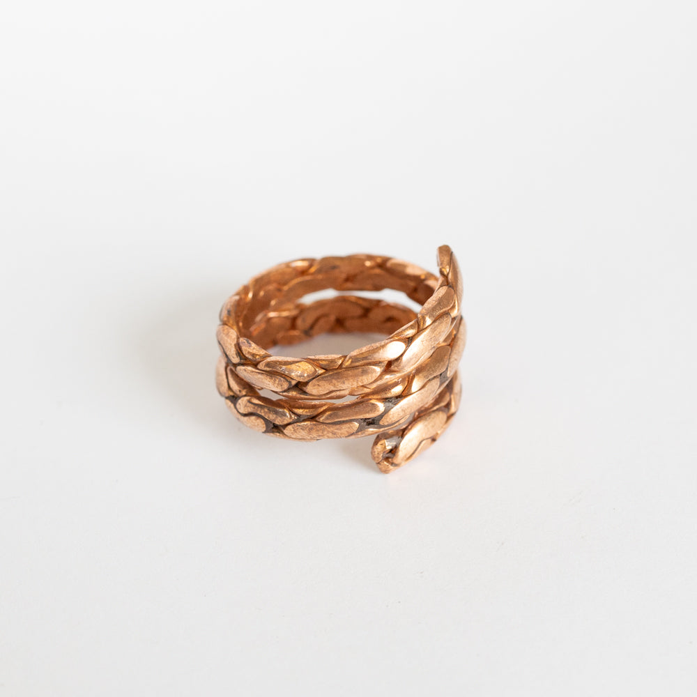 Copper textured twisted ring on white background