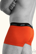 Men's orange bamboo boxers on male model side view
