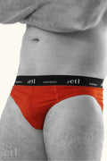 Mens underwear orange briefs on male model