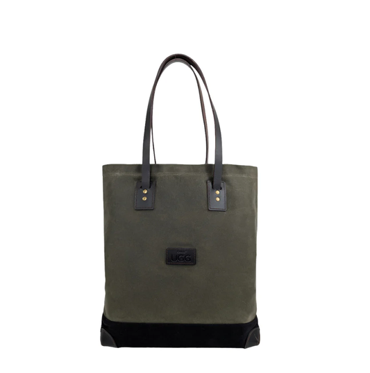 Green canvas tote bag with black leather accents on a white background