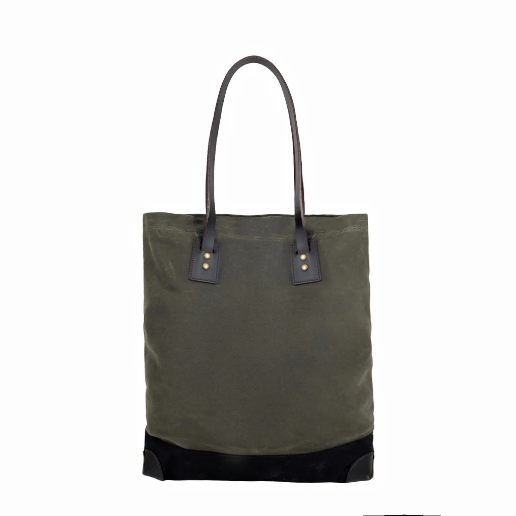 Green canvas tote bag with black leather accents on a white background