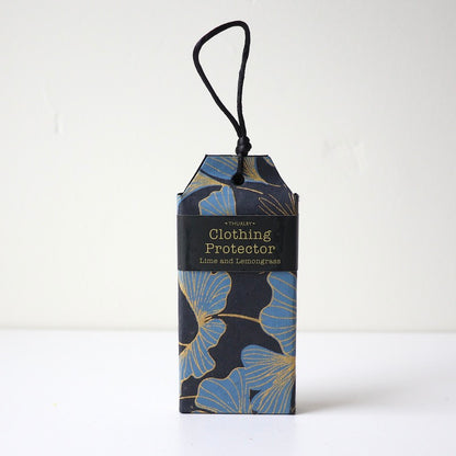 Lime & Lemongrass scented clothing protector sitting on table with string for hanging in wardrobe