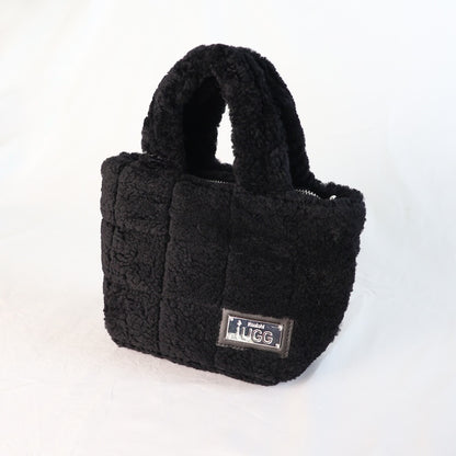 Black sheepskin handbag with a visible brand label on a white background