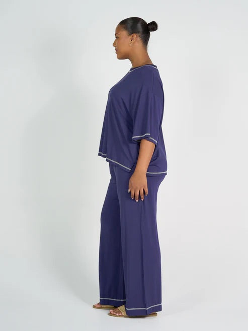 woman wearing blue bamboo shirt and pants on a white background