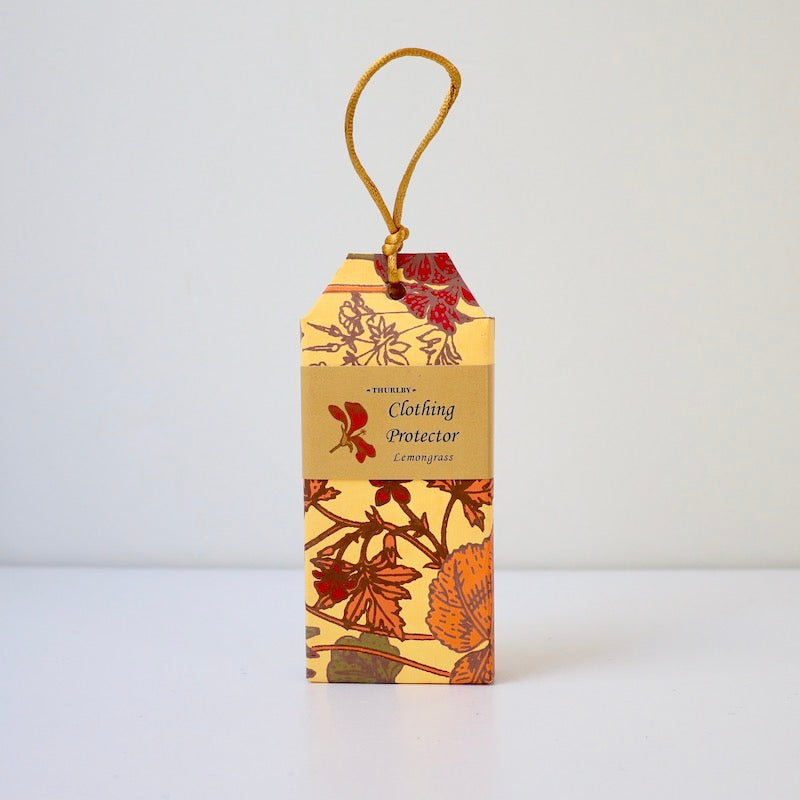 Lemongrass scented clothing protector moth repellent sitting on table with string on top for hanging in wardrobe