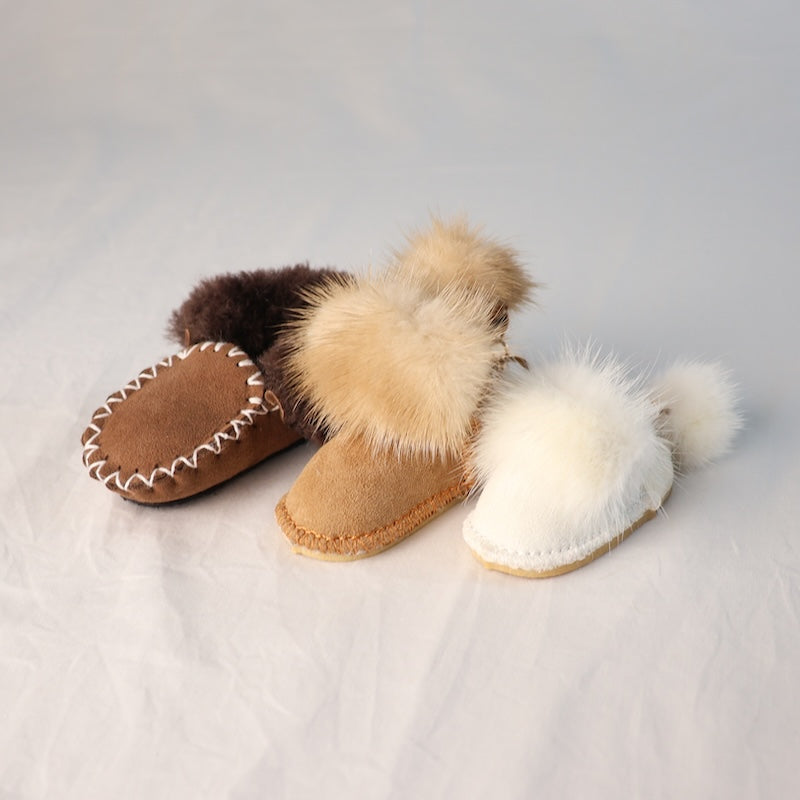 mini ugg keychains with fur trim on a light gray background