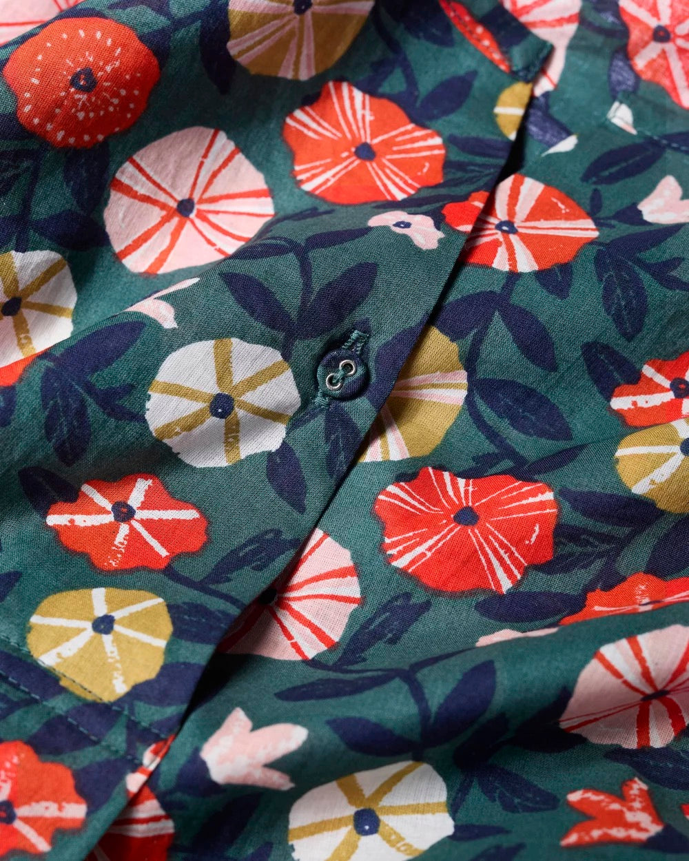 Close-up of a fabric with colorful floral pattern on a green background