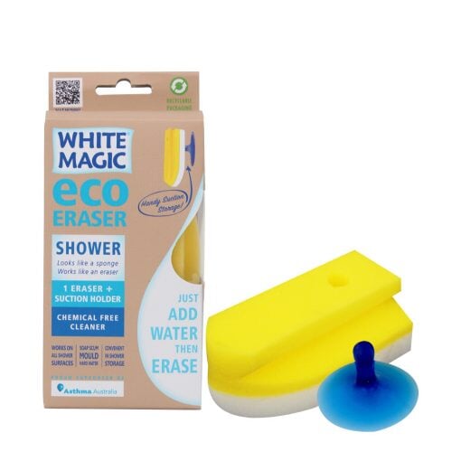 The image shows a yellow Shower Eraser by White Magic along with its packaging. The packaging is predominantly beige with product information and a blue suction hook illustrated on it.